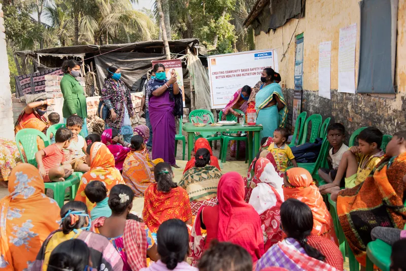 ASHA worker leads community health meeting
