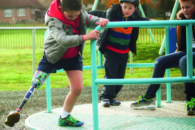 Child with prosthetic leg playing with friends
