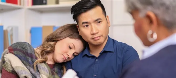 Couple receiving bereavement counseling from professional