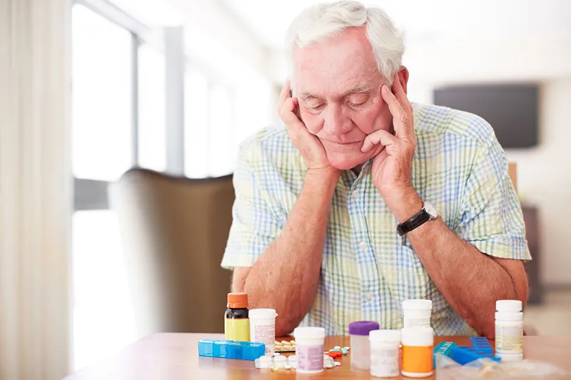Elderly man overwhelmed by multiple medications