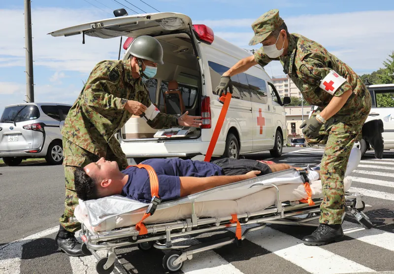 Loading patient into ambulance during mass casualty drill