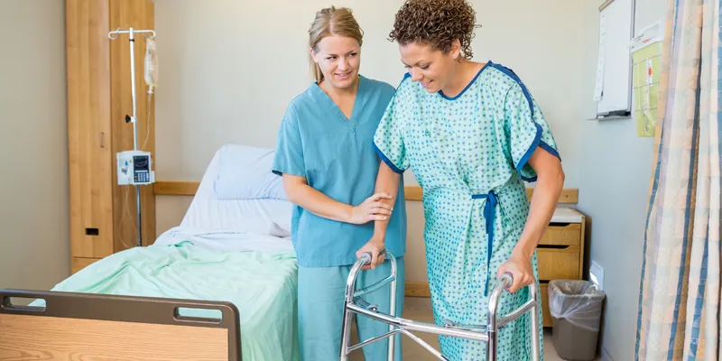 Post-operative patient ambulating with assistance