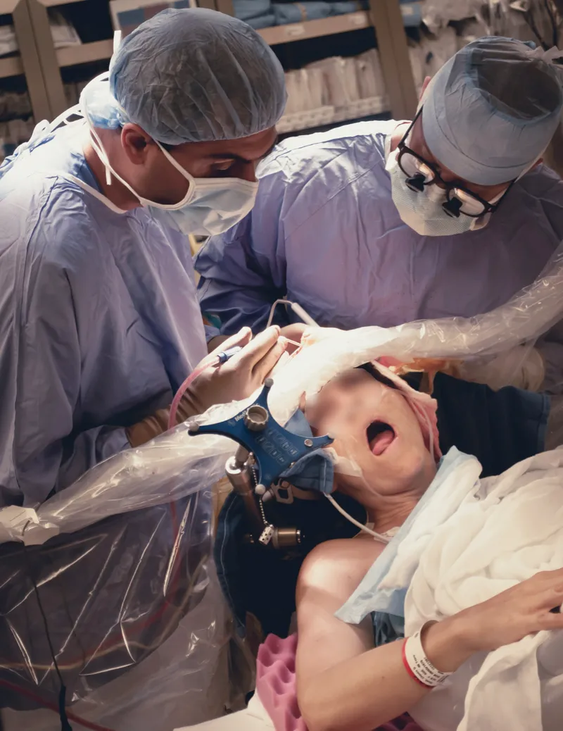Neurosurgeon performing awake craniotomy with patient conscious
